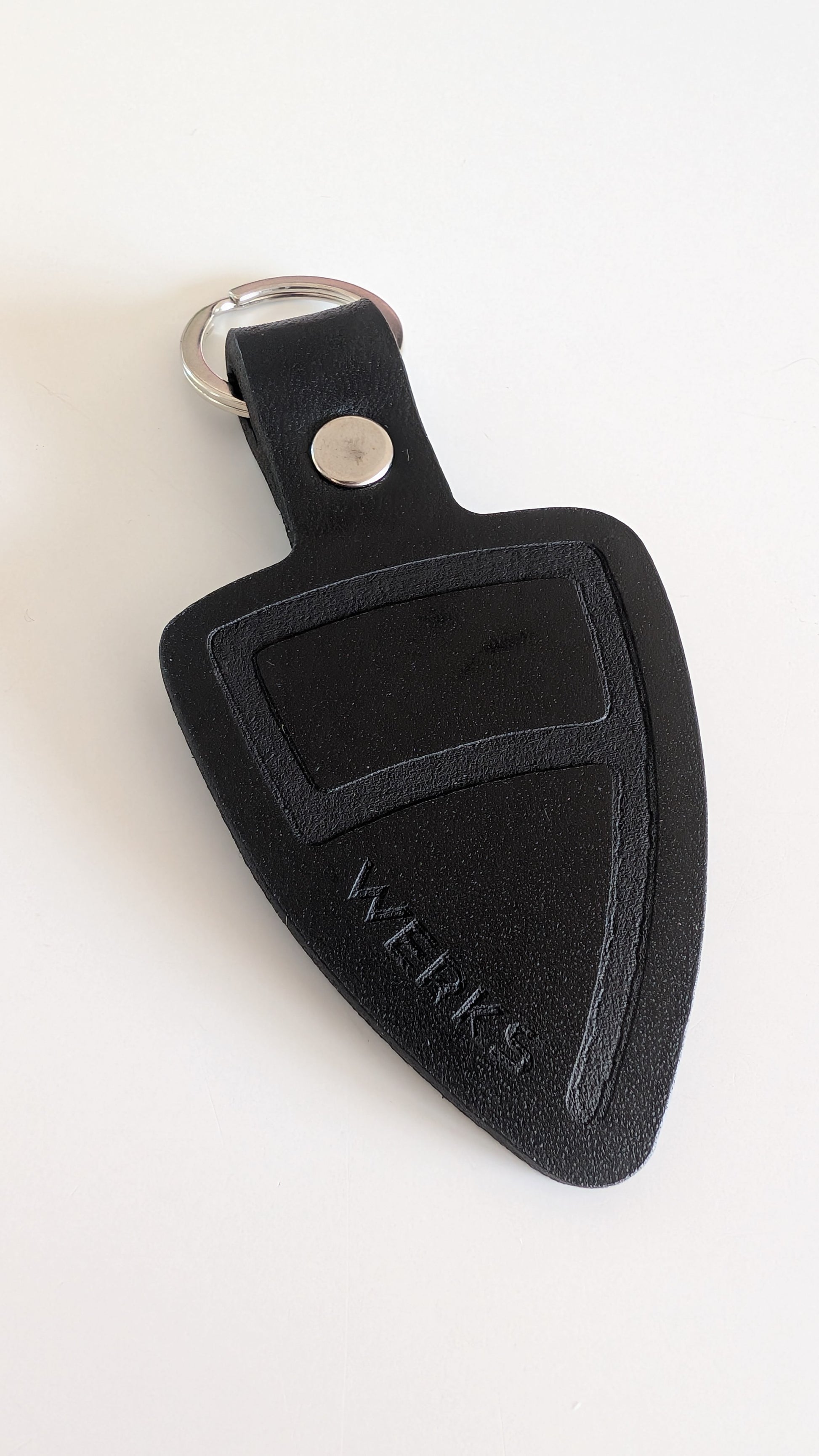 Black leather key fob with a brand logo on a white background